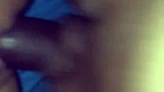 In the dimly lit room, an interracial couple engages in passionate sex, her pussy growing wet with desire.