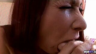 Redhead interacts with cougar in deepthroat scene