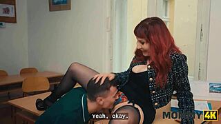 TEACHER DISCUSSES JOB WITH STUDENT IN CLASSROOM