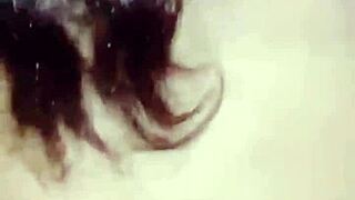 Amosinas chats with a friend in the airport bathroom