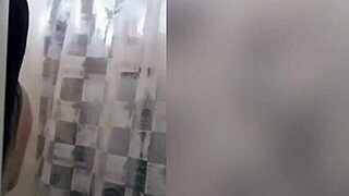 Cute latina teen enjoys a relaxing shower on webcam with tattoos
