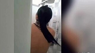 Cute latina teen enjoys a relaxing shower on webcam with tattoos