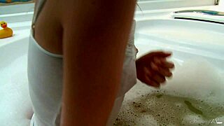 Renzy F's handheld shower teases her shaved pussy to juicy climax