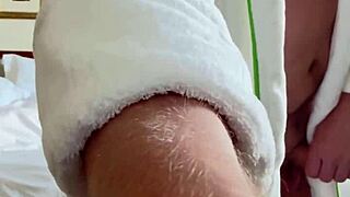 Muscular bodybuilder strokes monster cock by open hotel window flashing tan lines