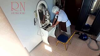 Hidden camera watches barber make nude lady undress for haircut session.