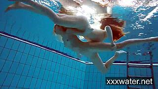 Milana and Katrin rip bikinis stripping nude underwater at beach pool.