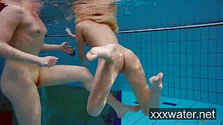 Milana and Katrin rip bikinis stripping nude underwater at beach pool.