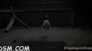 In the garage a gagged woman endures strict discipline for her rude ways