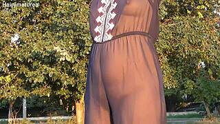 Hairy mature beaver flashes chubby pussy see-through outdoors