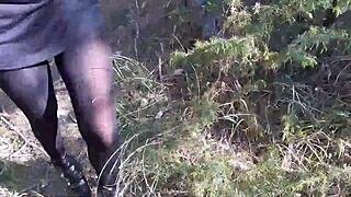 Woman struts sexy in high heels pantyhose strolling deep through forest woods