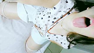 A cute girl in a white skirt and t-shirt explores tongue play and solo time.