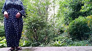 sweet stepmom helps stepson pee standing outdoors