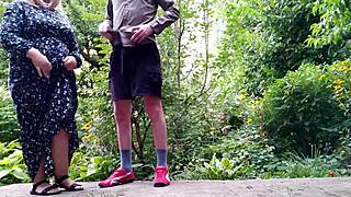 sweet stepmom helps stepson pee standing outdoors