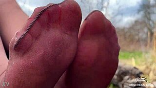 Imagine her nylon-clad feet teasing you in the forest spring—can you resist spreading for her toes?