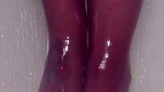 nylon feet tease and glisten under shower water in steamy bathroom display