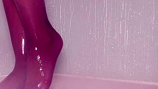 nylon feet tease and glisten under shower water in steamy bathroom display