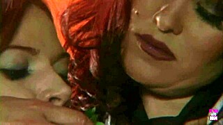 a redheaded lesbian babe forces big breasted lady to eat cakes and fruit in erotic play